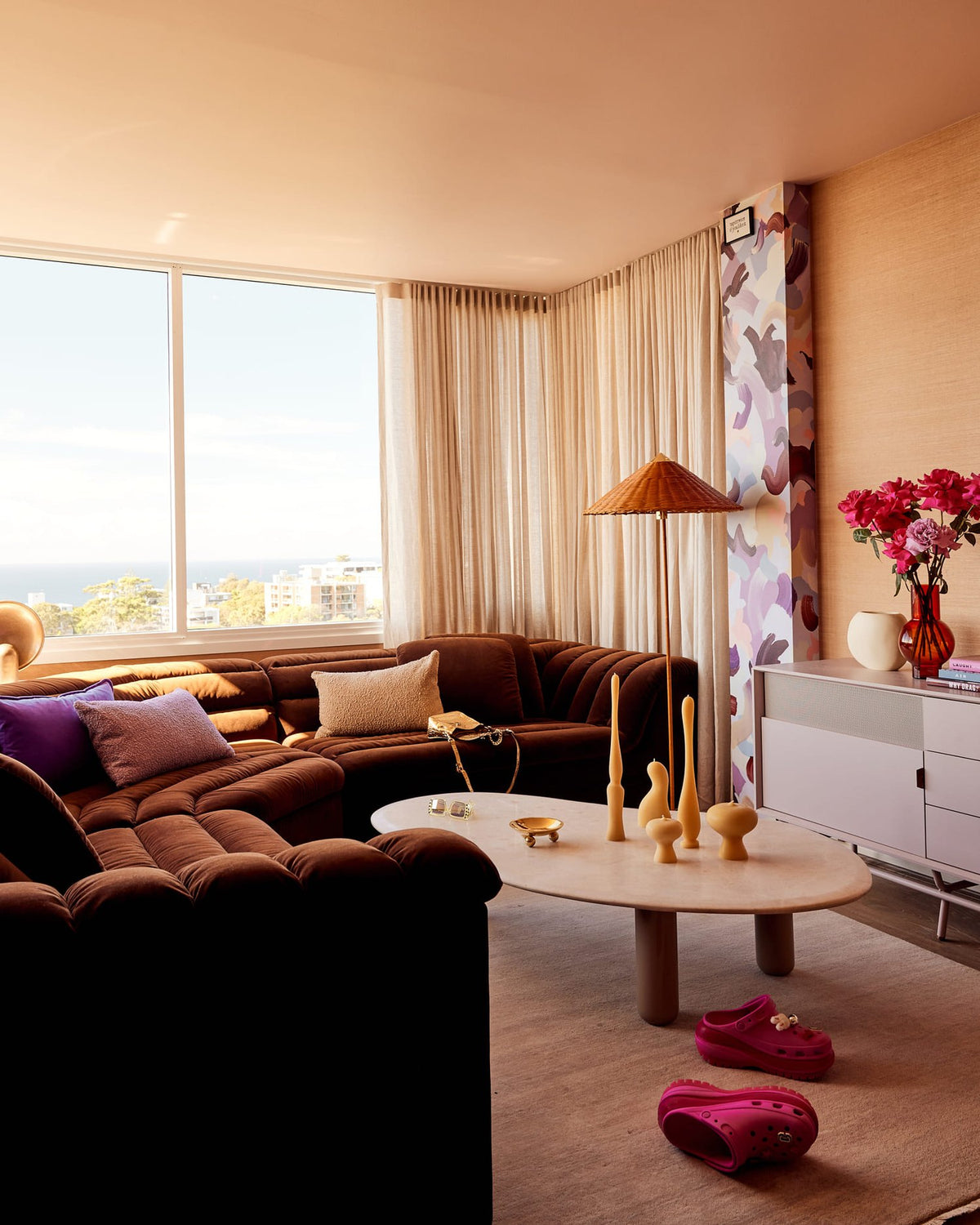 Living room in Courtney Act's Sydney home with floor-to-ceiling curtains by drapeCo, as featured on The Design Files